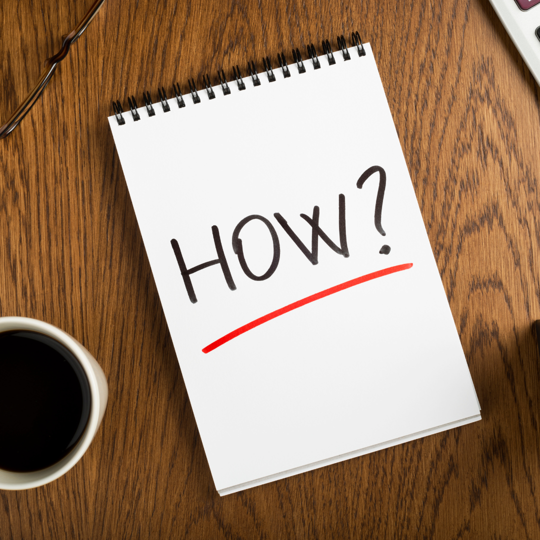 Healthy Home & Office - Notebook with 'HOW?' text on a wooden table with a cup of coffee