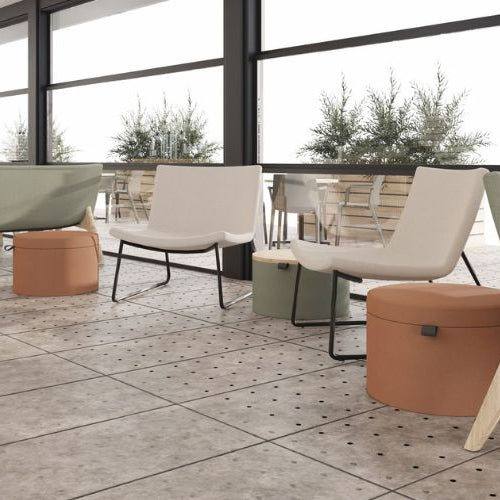 Modern outdoor furniture set with chairs and ottomans on a tiled patio.