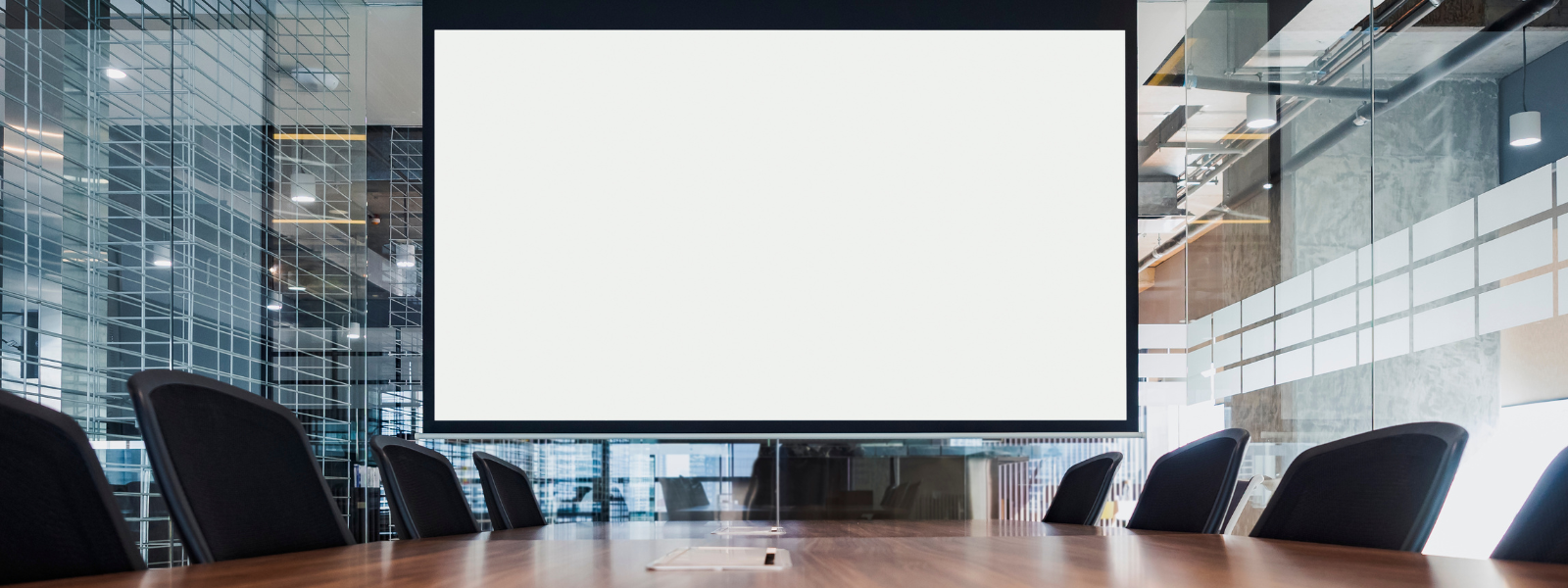 Healthy Home & Office - Modern conference room with a large screen and chairs arranged around a table.